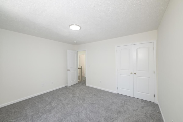 9133 Belvedere Rd # 5020, Tobyhanna, PA 18466 - unfurnished bedroom with carpet, baseboards, a closet, and a textured ceiling