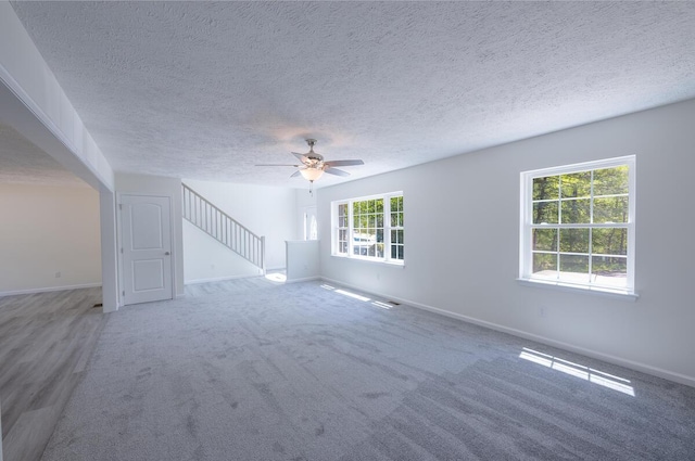 9133 Belvedere Rd # 5020, Tobyhanna, PA 18466 - unfurnished living room with a ceiling fan, baseboards, a textured ceiling, and carpet flooring