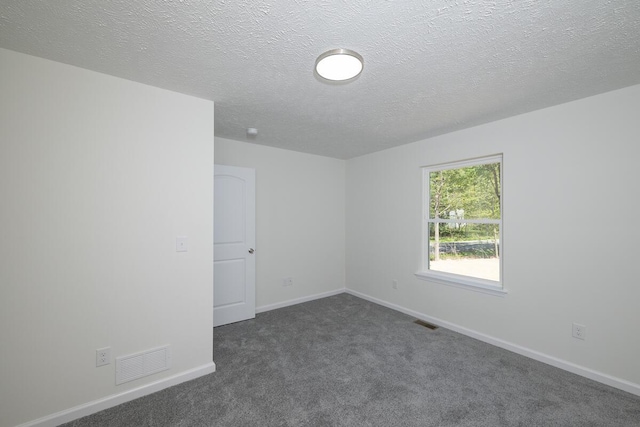 9133 Belvedere Rd # 5020, Tobyhanna, PA 18466 - spare room with dark colored carpet, a textured ceiling, and baseboards