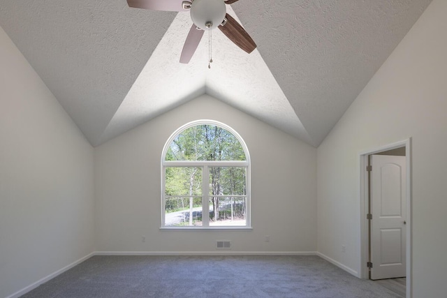 9133 Belvedere Rd # 5020, Tobyhanna, PA 18466 - spare room with carpet flooring, a ceiling fan, baseboards, a textured ceiling, and vaulted ceiling