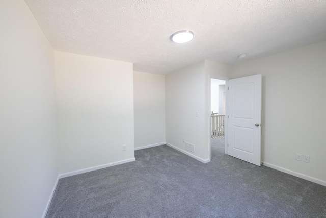 9133 Belvedere Rd # 5020, Tobyhanna, PA 18466 - unfurnished room with dark carpet, baseboards, and a textured ceiling