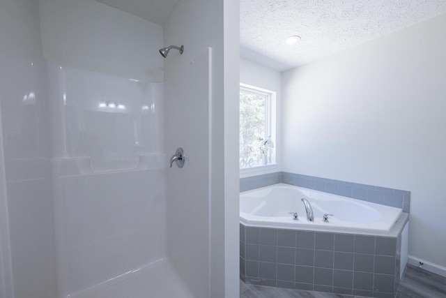 9133 Belvedere Rd # 5020, Tobyhanna, PA 18466 - bathroom featuring a bath, a shower, and a textured ceiling