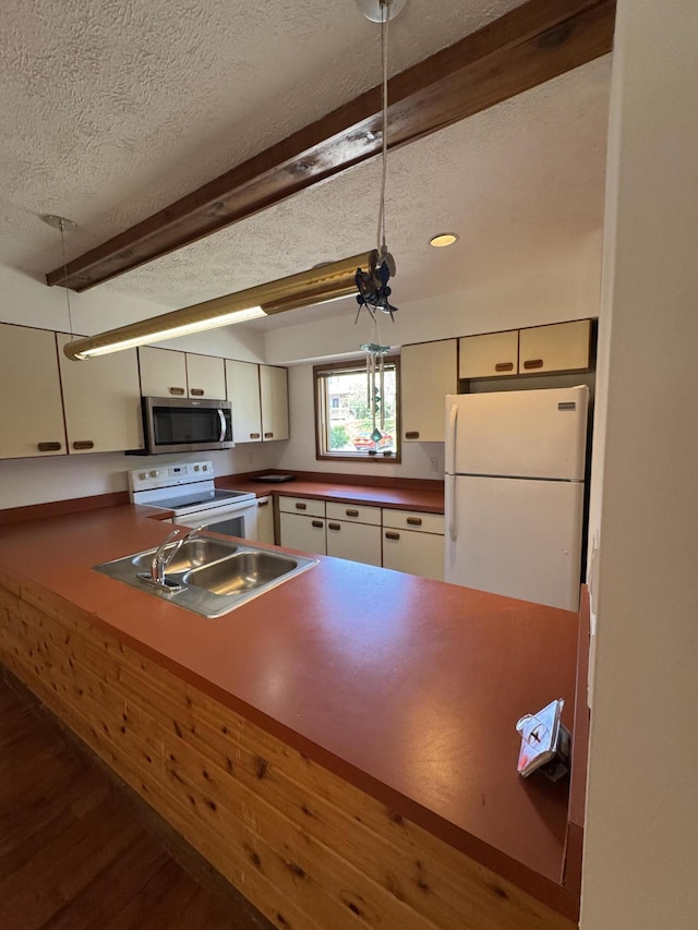 282 Northslope Ii Rd, East Stroudsburg, PA 18302 - kitchen featuring white appliances, a textured ceiling, wood finished floors, beam ceiling, and dark countertops