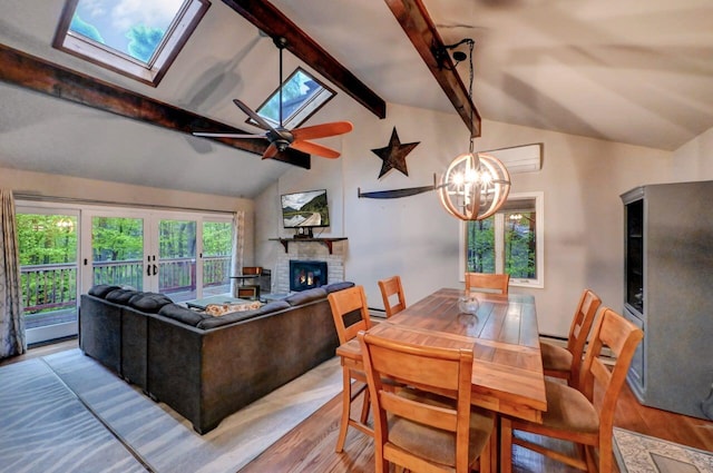 3207 Green Meadow Cir, Pocono Pines, PA 18350 - living room featuring a skylight, wood finished floors, a glass covered fireplace, ceiling fan, and french doors