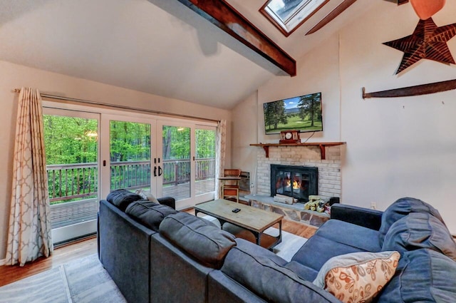 3207 Green Meadow Cir, Pocono Pines, PA 18350 - living room featuring a skylight, beamed ceiling, wood finished floors, french doors, and a fireplace