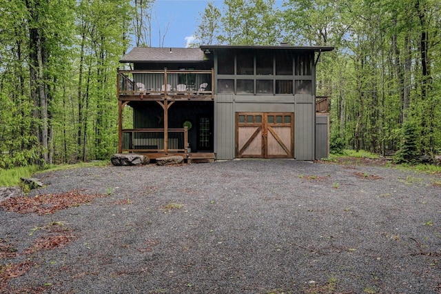 3207 Green Meadow Cir, Pocono Pines, PA 18350 - view of front of home with a wooden deck, driveway, and a garage