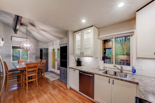 3207 Green Meadow Cir, Pocono Pines, PA 18350 - kitchen featuring stainless steel dishwasher, a sink, lofted ceiling, light wood finished floors, and white cabinets