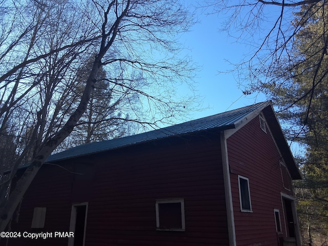 view of side of property with metal roof