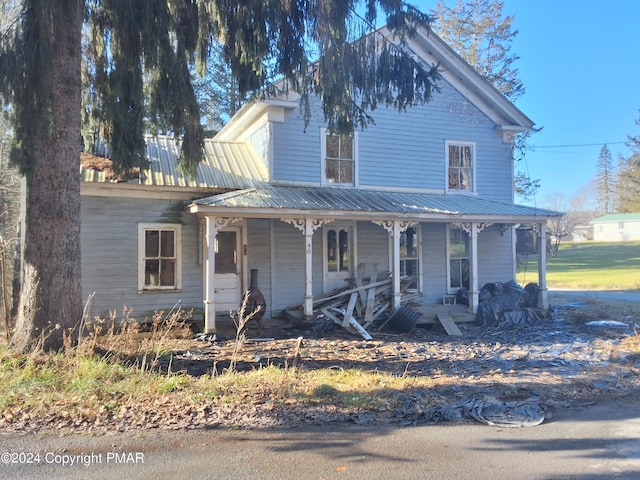 view of front of property featuring covered porch and metal roof