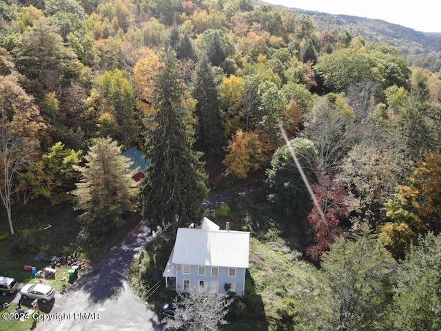 drone / aerial view featuring a view of trees