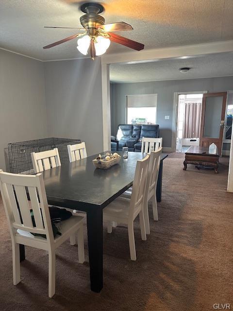 dining space with carpet floors and ceiling fan