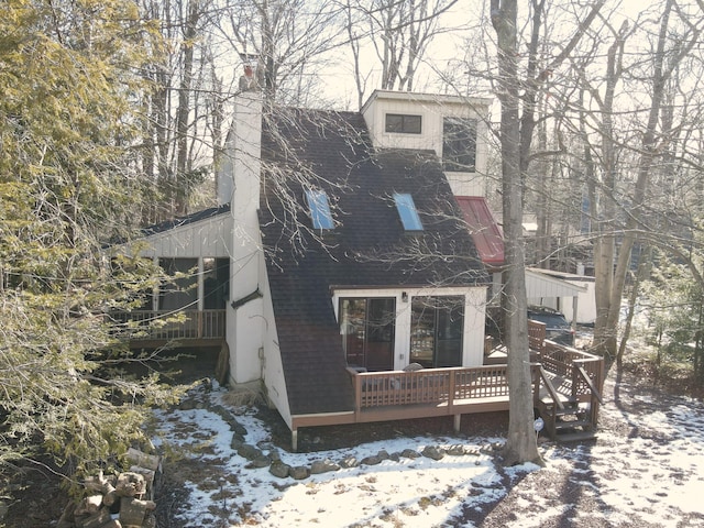 view of front facade with a deck and a chimney