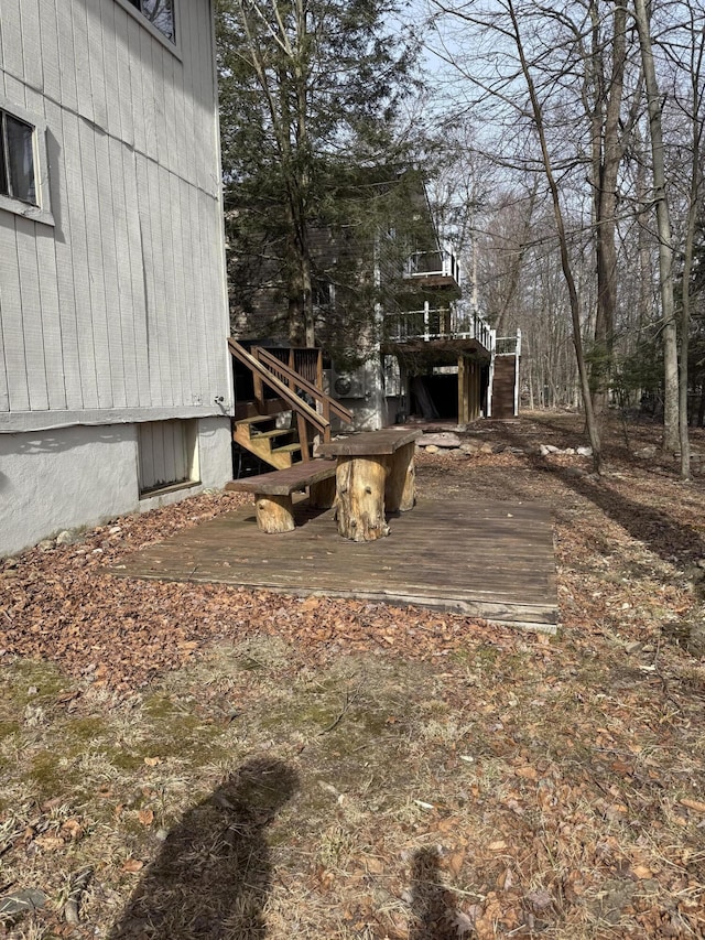 view of yard with stairs and a wooden deck