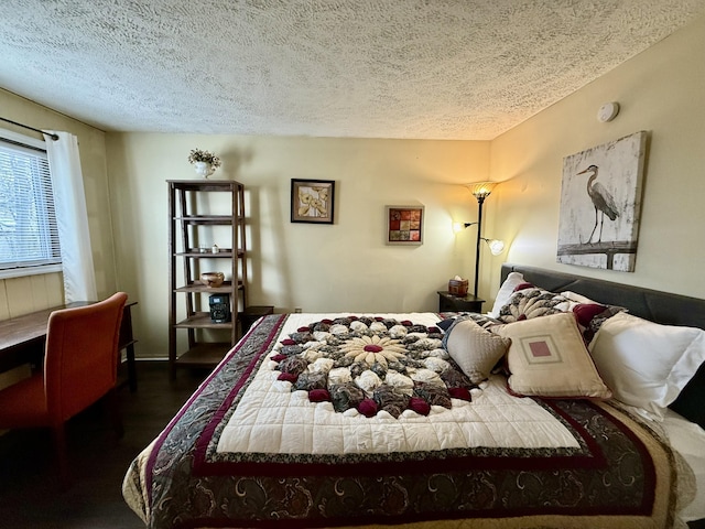 bedroom featuring dark wood-style floors and a textured ceiling