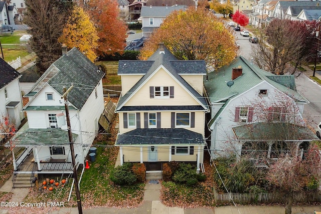 view of front of house featuring a residential view and roof with shingles