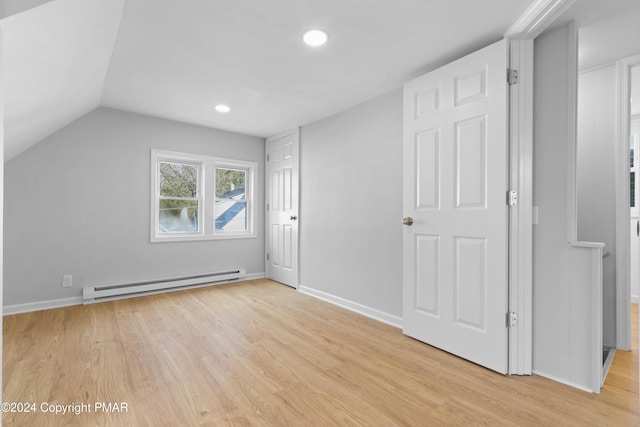 bonus room featuring lofted ceiling, recessed lighting, baseboard heating, light wood-style floors, and baseboards