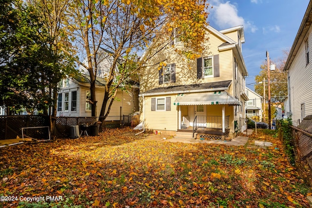 rear view of house with a fenced backyard