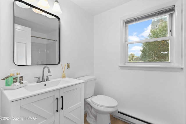 bathroom with baseboard heating, vanity, and toilet