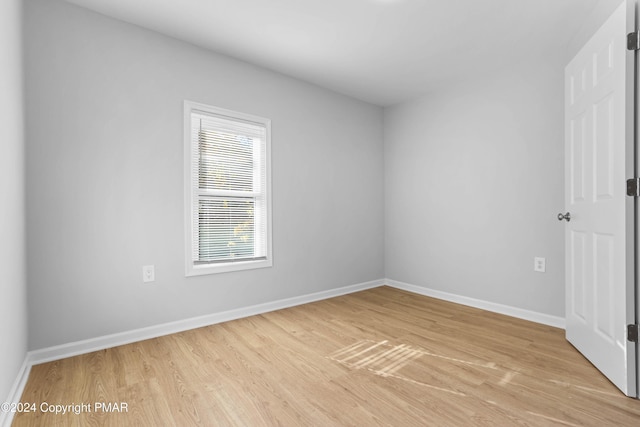 empty room featuring light wood-style floors and baseboards