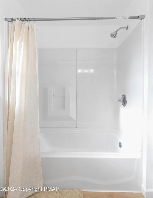 bathroom featuring shower / bath combo with shower curtain