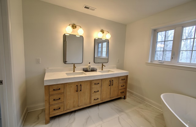 109 Forest Lake Dr, Jim Thorpe, PA 18229 - full bathroom featuring marble finish floors, double vanity, a freestanding tub, and healthy amount of natural light