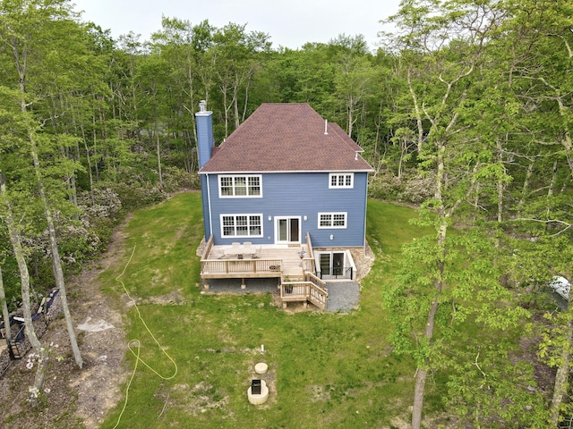 109 Forest Lake Dr, Jim Thorpe, PA 18229 - back of property with a chimney, a wooden deck, a wooded view, a lawn, and roof with shingles