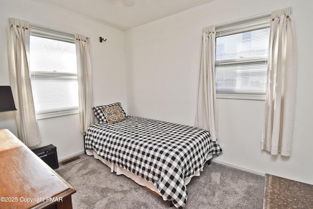 carpeted bedroom featuring visible vents and baseboards