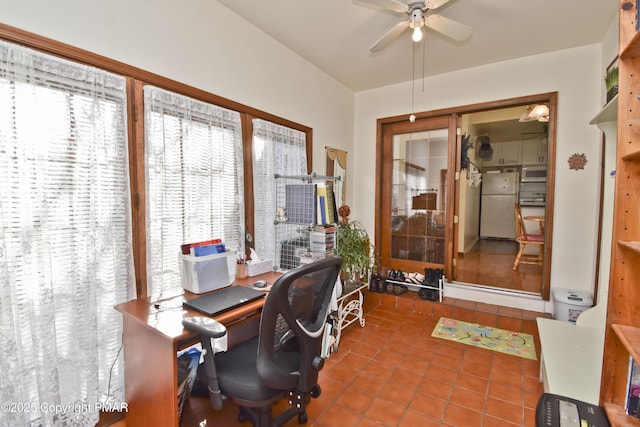 tiled office space with a ceiling fan