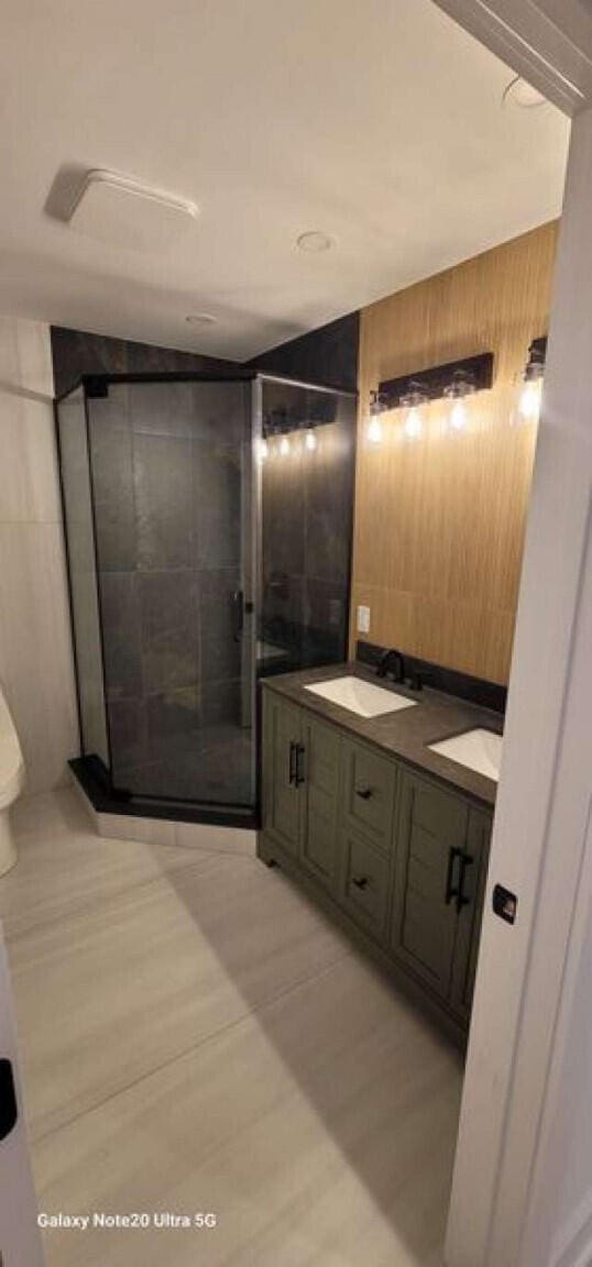 2210 White Oak Trl, Pocono Pines, PA 18350 - bathroom with toilet, tile walls, a shower stall, and vanity