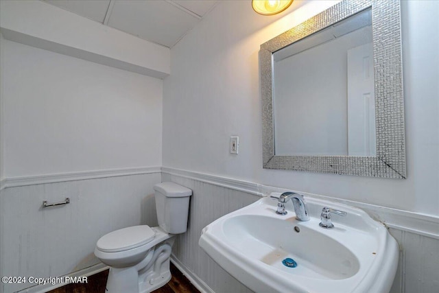 120 St Andrews Dr, Bushkill, PA 18324 - half bathroom with wainscoting, toilet, and a sink