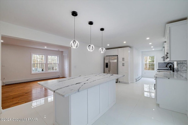 120 St Andrews Dr, Bushkill, PA 18324 - kitchen featuring stainless steel fridge with ice dispenser, a sink, a center island, baseboard heating, and light stone counters