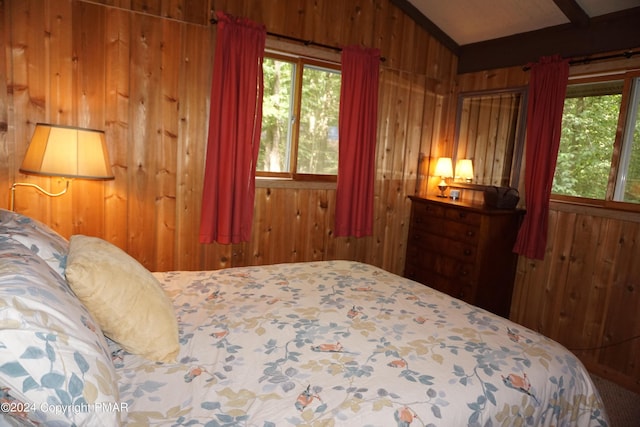 bedroom featuring wood walls