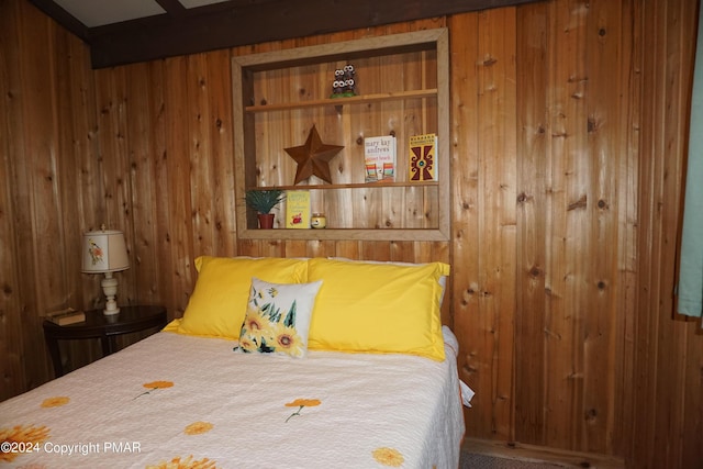 bedroom featuring wooden walls