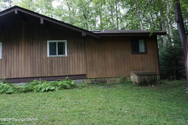 view of property exterior with a yard