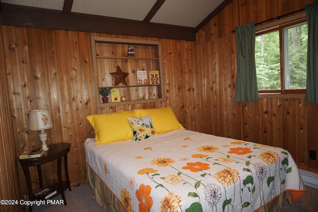 carpeted bedroom with wooden walls and vaulted ceiling