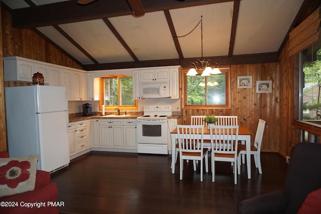 kitchen featuring vaulted ceiling with beams, a sink, wooden walls, a chandelier, and white appliances