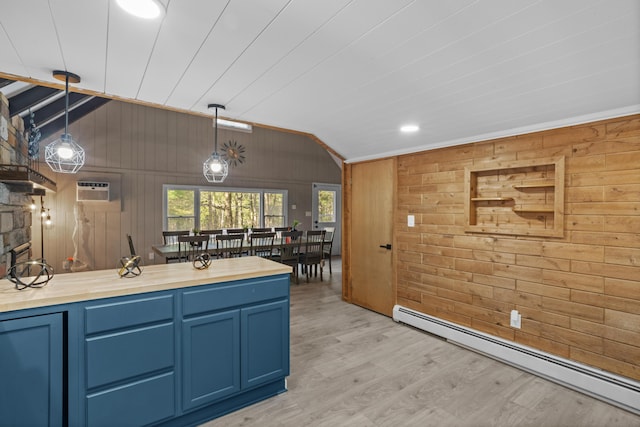 371 Echo Lake Rd, Tobyhanna, PA 18466 - kitchen with a baseboard heating unit, wooden walls, blue cabinets, vaulted ceiling, and light wood-type flooring