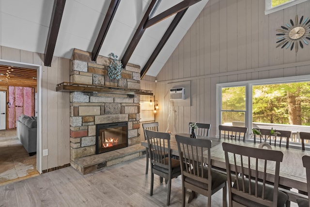 371 Echo Lake Rd, Tobyhanna, PA 18466 - dining space with high vaulted ceiling, beamed ceiling, wood walls, healthy amount of natural light, and a fireplace