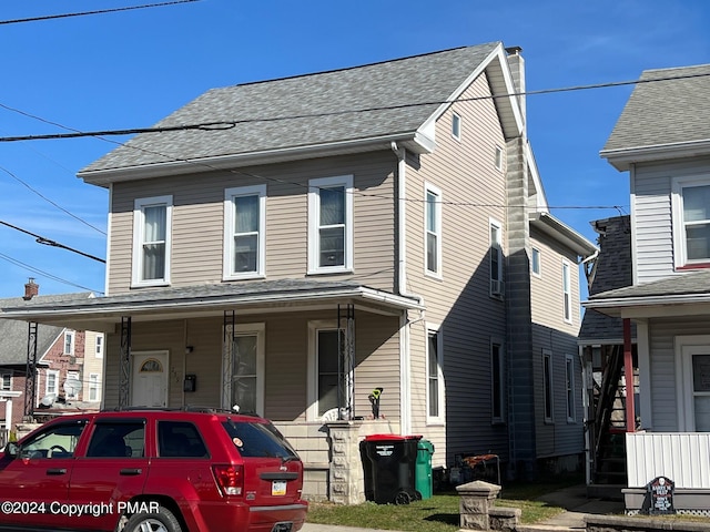 view of front of home featuring a porch and a shingled roof