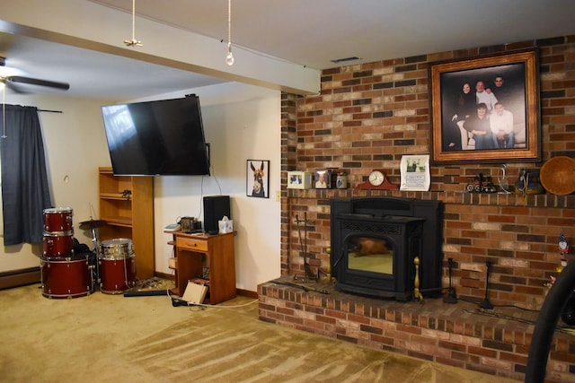 8044 Promontory Dr, White Haven, PA 18661 - living area featuring carpet, a ceiling fan, a wood stove, and baseboards