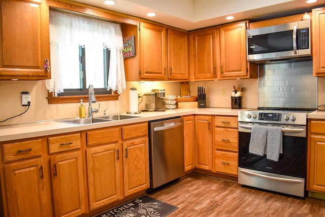 8044 Promontory Dr, White Haven, PA 18661 - kitchen with stainless steel appliances, a sink, light countertops, light wood finished floors, and recessed lighting