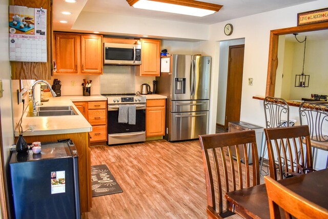 8044 Promontory Dr, White Haven, PA 18661 - kitchen with appliances with stainless steel finishes, a sink, light countertops, light wood-style flooring, and recessed lighting