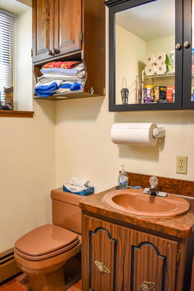 8044 Promontory Dr, White Haven, PA 18661 - half bathroom with toilet, vanity, and a baseboard heating unit
