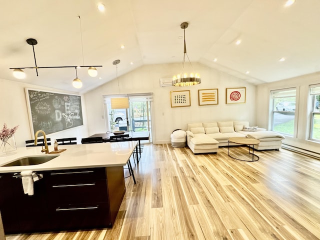 1110 Lehigh Cir, Tobyhanna, PA 18466 - kitchen featuring open floor plan, lofted ceiling, light wood-style floors, light countertops, and plenty of natural light