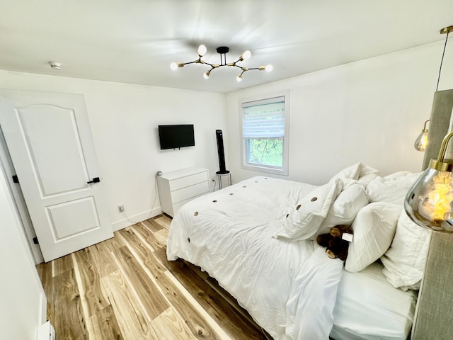 1110 Lehigh Cir, Tobyhanna, PA 18466 - bedroom featuring light wood-type flooring and a chandelier