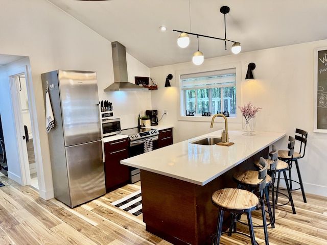 1110 Lehigh Cir, Tobyhanna, PA 18466 - kitchen with stainless steel appliances, wall chimney range hood, a kitchen breakfast bar, light wood-style floors, and lofted ceiling