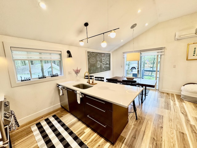 1110 Lehigh Cir, Tobyhanna, PA 18466 - kitchen with a wall unit AC, light wood-style floors, a peninsula, vaulted ceiling, and modern cabinets