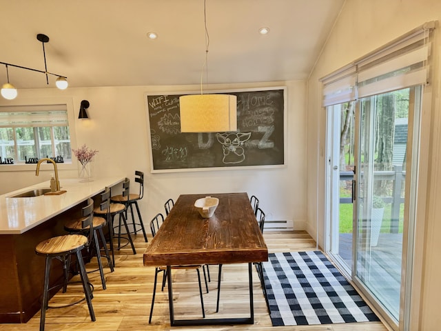 1110 Lehigh Cir, Tobyhanna, PA 18466 - dining space with plenty of natural light, wood finished floors, a baseboard radiator, lofted ceiling, and recessed lighting