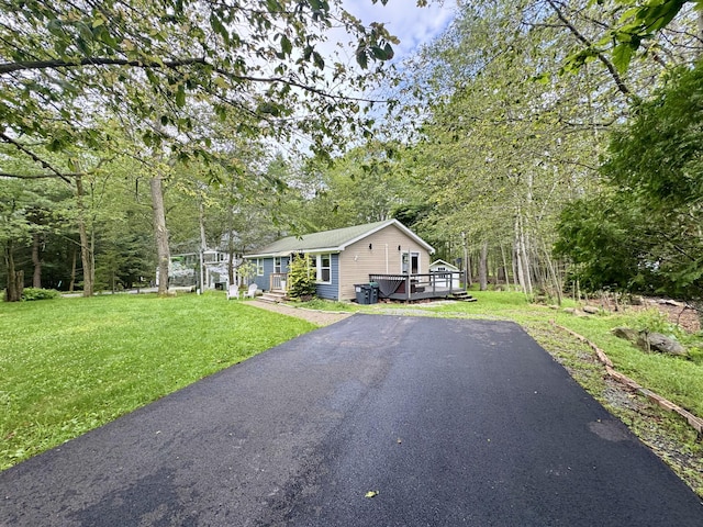 1110 Lehigh Cir, Tobyhanna, PA 18466 - view of front facade featuring a wooden deck, a front lawn, and asphalt driveway