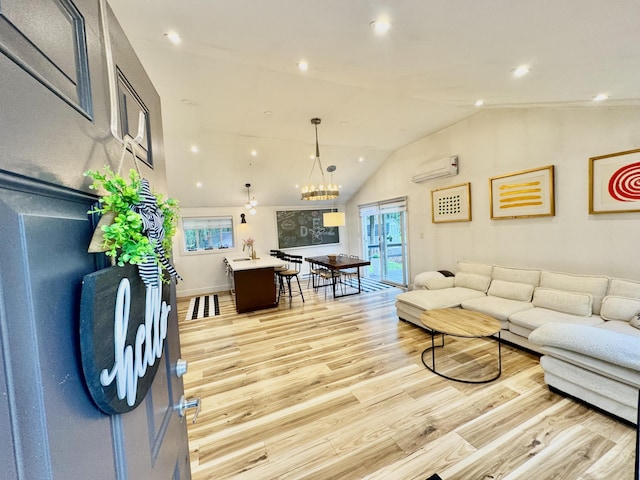 1110 Lehigh Cir, Tobyhanna, PA 18466 - living area featuring a wall mounted AC, vaulted ceiling, light wood-style flooring, recessed lighting, and a chandelier